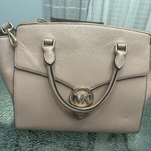 Michael Kors purse in a taupe-pink colored purse.